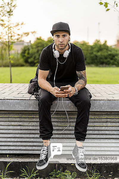 Young man using his smartphone in the city