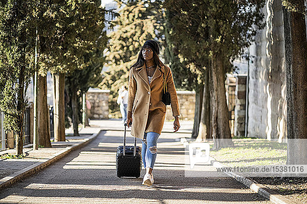 Female tourist with suitcase outdoors