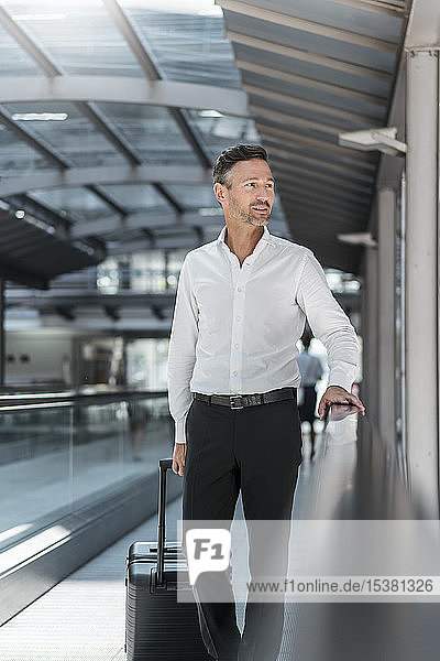 Businessman on moving walkway at the airport