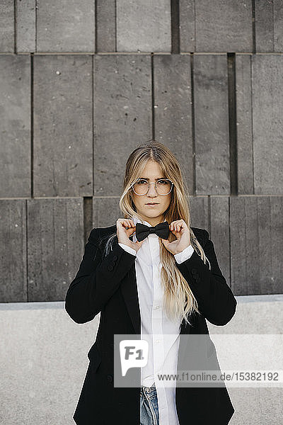 Portrait of blond young woman wearing black tie and blazer  Vienna  Austria