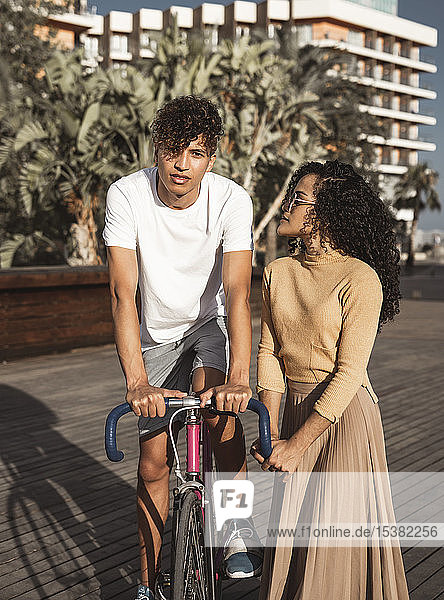 Cool couple with bicycle in the city