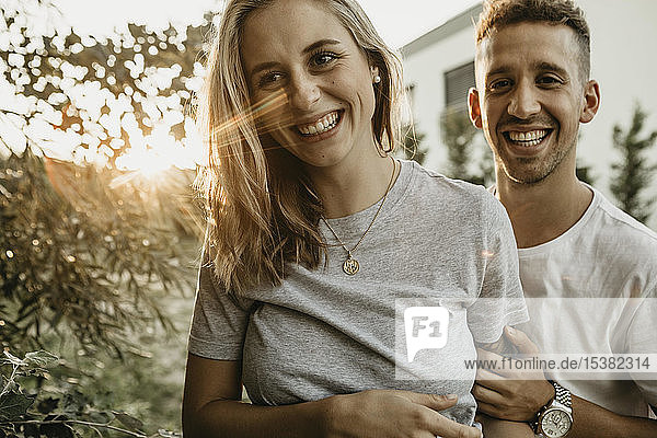 Portrait of young smiling couple a sunset