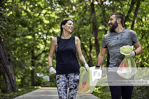 Couple plogging on forest path
