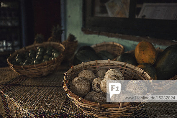 Close-up of woodapples in wicker baskets on table at home