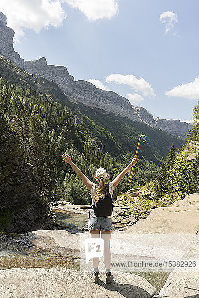 Rear view of happy woman enjoying the view in the mountains  Ordesa national park  Aragon  Spain