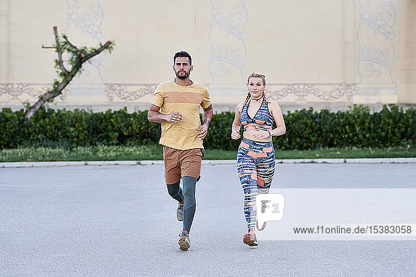 Man and woman running in the city