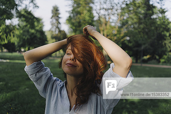 Portrait of redheaded woman in a park