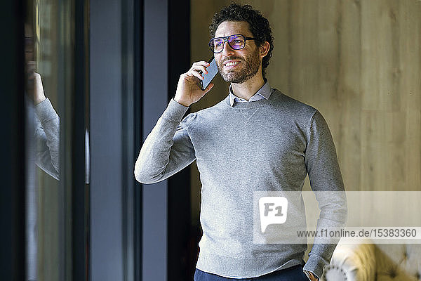 Smiling businessman talking on the phone