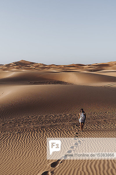 Young woman walking in the desert  Merzouga  Morocco