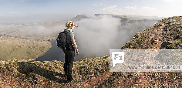 UK  Wales  Brecon Beacons  Young woman hiking at Bannau Sir Gaer Ridge