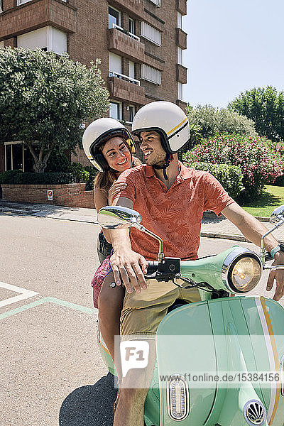 Young couple on a vintage motor scooter