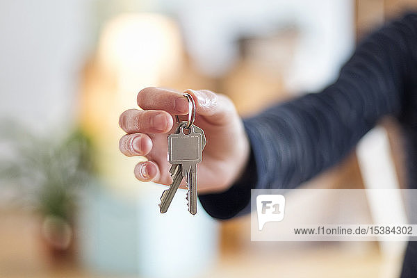 Close-up of man holding house key in new home