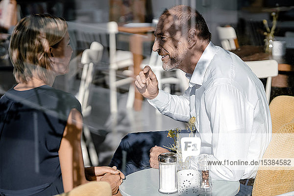 Businessman and woman having a meeting in a coffee shop