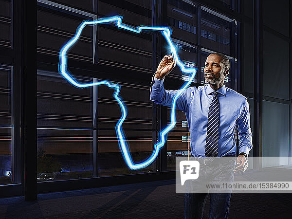 Geschäftsmann malt Afrika mit Licht