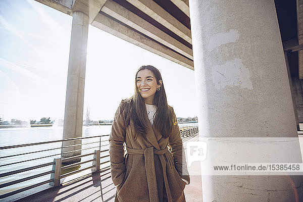 Smiling young woman at a lake