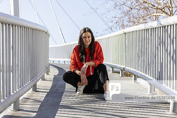 Young contemporary dancer on a footbridge  resting