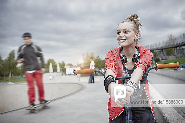 Teenage girl with bmx bike at a skatepark