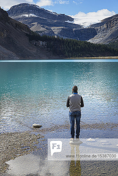 Canada  Jasper and Banff National Park  Icefields Parkway  man at lakeside
