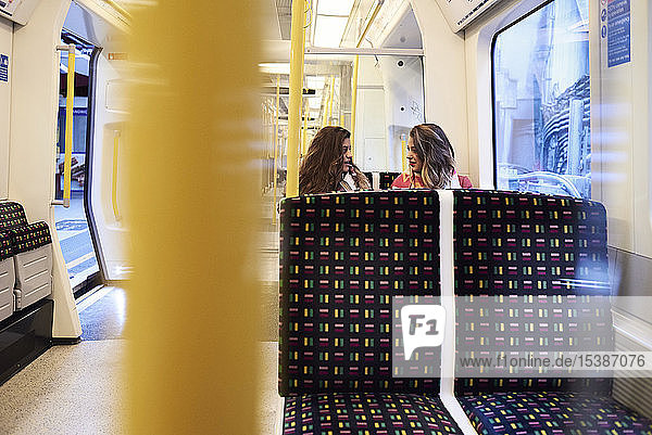 UK London two women talking in underground train