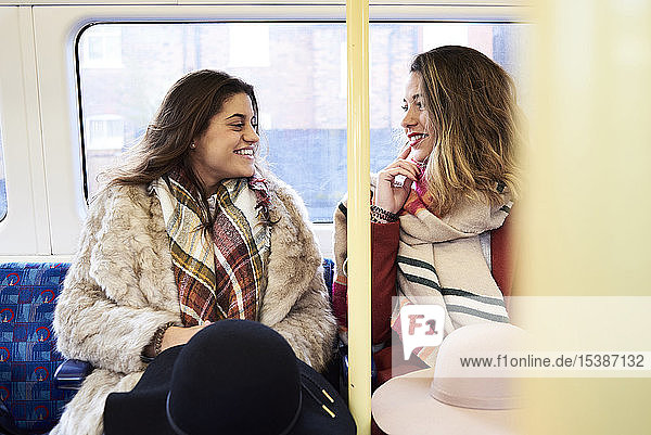 UK London two happy women in underground train