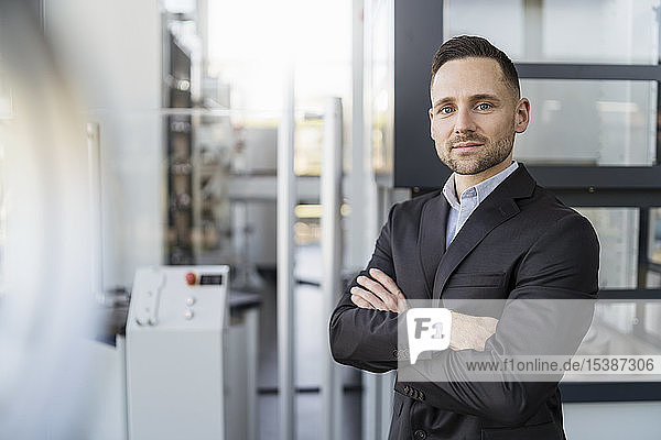 Portrait of confident businessman in a modern factory