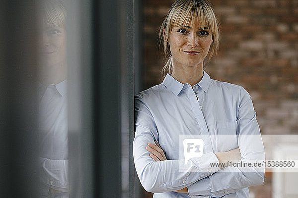 Portrait of a blond businesswoman with arms crossed