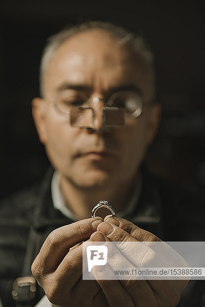 Artisan looking at ring with gemstone  portrait