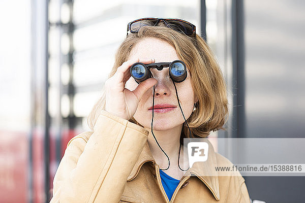 Portrait of woman using binoculars