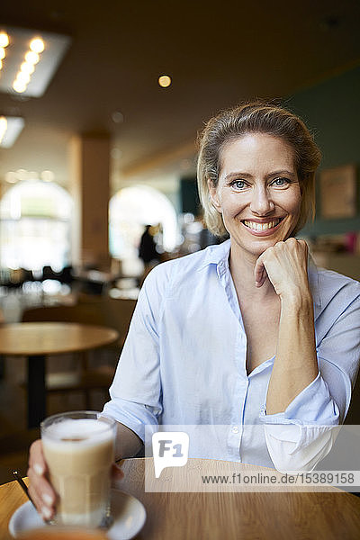 Portrait of smiling woman in a cafe