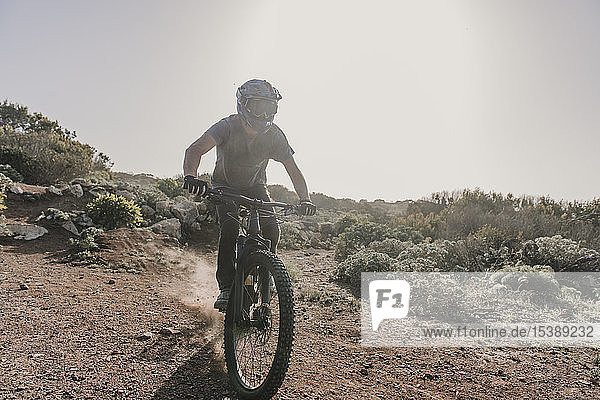 Spain  Lanzarote  mountainbiker on a trip in desertic landscape