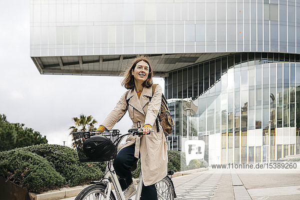 Porträt einer E-Bike fahrenden Frau in der Stadt