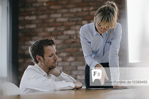 Business people working together on a project using laptop