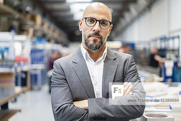 Portrait of confident businessman in factory