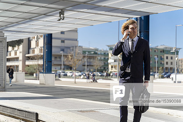 Italy  Florence  young businessman on smartphone outdoor