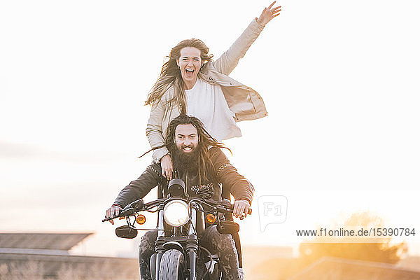 Portrait of happy couple on motorbike