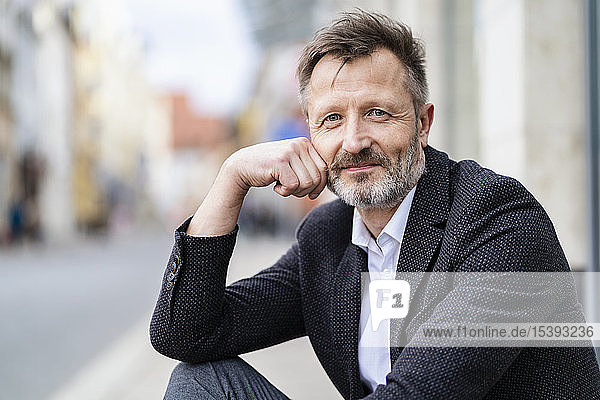 Portrait of content mature businessman with greying beard