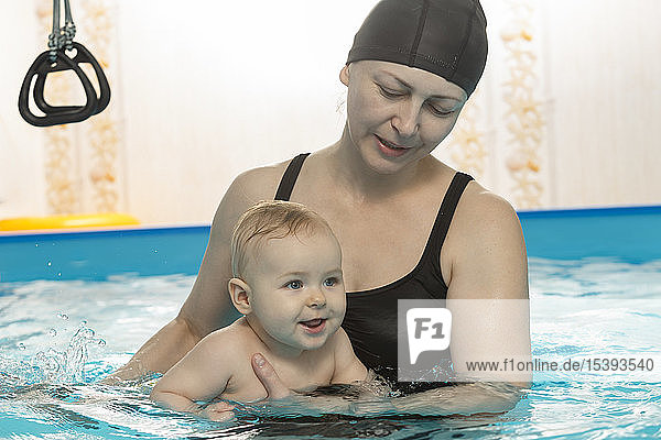 Baby swimming  mother with daughter in swimming pool