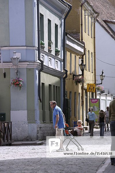 A Man with a Shopping Cart in the Street