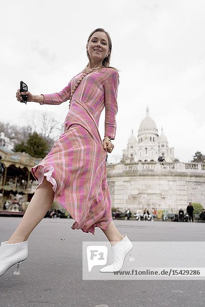 Stylish blogger woman in front of touristic sight Basilica Sacré-Cœur during fashion week in city Paris France in city Paris France