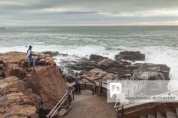 USA Maine Mt. Desert Island Acadia National Park coastal view by Thunder Hole with visitor NR.