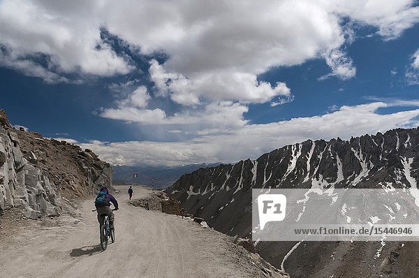 LADAKH INDIA August 2012 Cyclist at Khardungla Pass the highest motor road in the world.