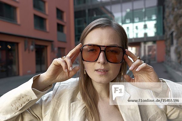 Stylish woman wearing oversized orange sunglasses