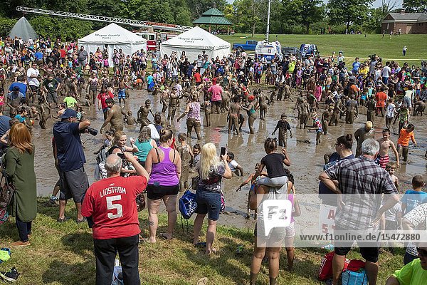 Westland Michigan - Children age 12 and younger along with some parents play in the mud during the annual 'Youth Mud Day' organized by Wayne County Parks.
