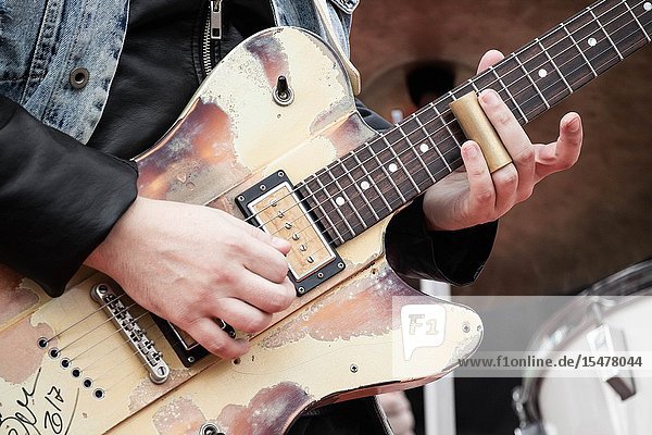 Musician playing slide guitar at outdoor concert on Gran Canaria.