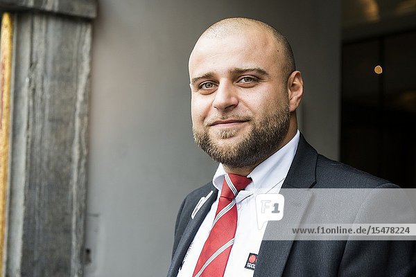 Brussels Belgium. Male security guard posting at a bank office entrance.