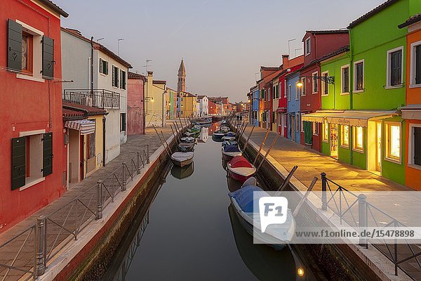 The typical colored houses with Rio della Giudecca Canal at sunset Burano Island Venice Veneto Italy.