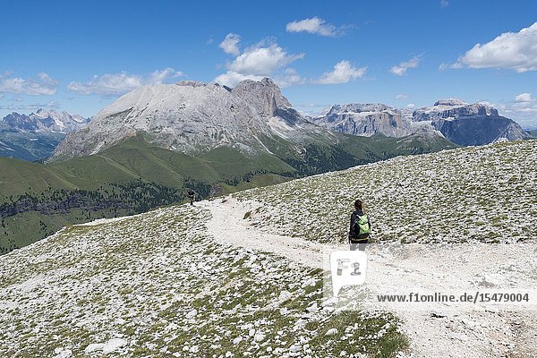 Italy dolomites Trentino South Tyrol fassa valley Hiker on his way to the Dona Val from the Antermoia refuge.