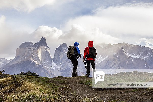 Chile Patagonia Magallanes and Chilean Antarctica Region Ultima Esperanza Province Torres del Paine National Park two person chat while watching Paine Horns.
