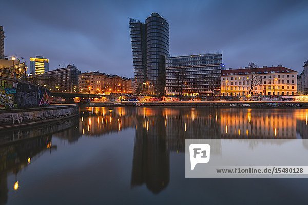 Vienna Austria Europe. The Uniqa Tower reflected in the Danube Canal.