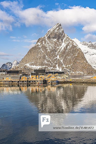 Olstinden peak reflecting on the sea at Sariskoy. Reine Lofoten district Nordland county Northern Norway Norway.
